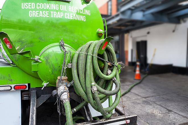 large truck pumping grease trap at a restaurant in Bridgeview